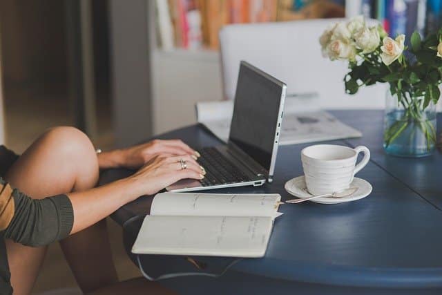 Woman typing a blog on a laptop