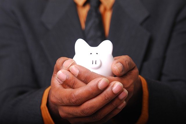 Hands holding a piggy bank